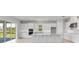 Bright kitchen featuring an island, lots of cabinet space, stainless steel appliances, and a sliding glass door to patio at 5641 Nevis Ter, Kissimmee, FL 34758