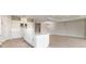 Open kitchen with large island, white cabinets and leads into living area at 5641 Nevis Ter, Kissimmee, FL 34758