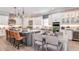 Modern kitchen with an island, stainless steel appliances, pendant lighting, and adjacent dining area at 5641 Nevis Ter, Kissimmee, FL 34758