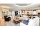 Open-concept living room showcasing hardwood floors, abundant natural light, and modern furnishings at 5641 Nevis Ter, Kissimmee, FL 34758