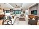 Spacious living room with large windows, comfortable seating, and stylish decor at 5641 Nevis Ter, Kissimmee, FL 34758
