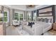 Elegant main bedroom with decorative pillows, chandelier, sitting area, and view to the outside at 5641 Nevis Ter, Kissimmee, FL 34758