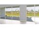 Wall of glass doors looking out onto landscaped yard, water and community at 5641 Nevis Ter, Kissimmee, FL 34758