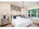 Tastefully decorated bedroom featuring a large window, chandelier, and unique decorative wall hanging at 5647 Nevis Ter, Kissimmee, FL 34758