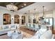 Open-concept living room and kitchen with ample seating, modern lighting, and luxury finishes at 5647 Nevis Ter, Kissimmee, FL 34758
