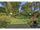Lush backyard featuring vibrant bamboo, a grass lawn, and decorative lighting perfect for outdoor enjoyment at 605 Sweetbriar Rd, Orlando, FL 32806