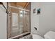 Modern bathroom features a glass shower, wood ceiling, and whimsical wall art at 605 Sweetbriar Rd, Orlando, FL 32806