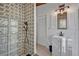 Elegant bathroom featuring a glass block shower, patterned wallpaper, and a sleek modern vanity at 605 Sweetbriar Rd, Orlando, FL 32806