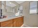 Bright bathroom featuring a wood vanity with marble countertop and a large mirror over the sink at 605 Sweetbriar Rd, Orlando, FL 32806