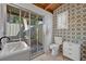 Stylish bathroom with patterned wallpaper, modern fixtures, and access to the outdoors at 605 Sweetbriar Rd, Orlando, FL 32806