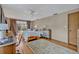 Bright bedroom with hardwood floors, large windows, ceiling fan, and warm decor at 605 Sweetbriar Rd, Orlando, FL 32806