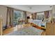 Bright bedroom with hardwood floors features a large window, ceiling fan, and neutral decor at 605 Sweetbriar Rd, Orlando, FL 32806