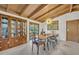 Dining room with wooden ceiling, cabinet with china, and natural light streaming through the doors at 605 Sweetbriar Rd, Orlando, FL 32806
