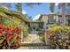 View of front entrance featuring a brick walkway, manicured foliage, and updated outdoor lighting at 605 Sweetbriar Rd, Orlando, FL 32806
