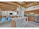 Open kitchen with an island, modern countertops, stainless steel appliances and seamless flow into living and dining area at 605 Sweetbriar Rd, Orlando, FL 32806