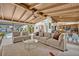 Open living room with comfortable seating and a glimpse of the kitchen and outdoor pool at 605 Sweetbriar Rd, Orlando, FL 32806