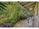 Charming outdoor patio with lush greenery, dining table, and a serene ambiance for relaxing and entertaining at 605 Sweetbriar Rd, Orlando, FL 32806