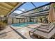 Relaxing screened-in pool with lounge chairs and a spacious patio area, perfect for outdoor entertaining and relaxation at 605 Sweetbriar Rd, Orlando, FL 32806