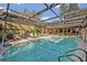The large screened-in pool area provides a relaxing outdoor oasis with a comfortable seating arrangement at 605 Sweetbriar Rd, Orlando, FL 32806