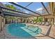 The screened-in pool offers a great view of the backyard and is perfect for hot summer days at 605 Sweetbriar Rd, Orlando, FL 32806
