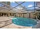 Spacious screened-in pool and patio featuring a diving board and beautiful landscaping for private outdoor enjoyment at 605 Sweetbriar Rd, Orlando, FL 32806