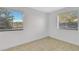 Minimalist bedroom with two windows covered with blinds allowing natural light at 626 Golden Sunshine Cir, Orlando, FL 32807