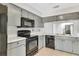 Galley kitchen with stainless steel appliances and gray cabinetry at 626 Golden Sunshine Cir, Orlando, FL 32807