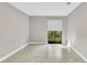 Open living room with tile flooring and sliding glass doors opening to the outside at 626 Golden Sunshine Cir, Orlando, FL 32807