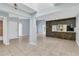 Spacious living room with tile floors, light walls, and breakfast bar at 626 Golden Sunshine Cir, Orlando, FL 32807