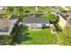 A high angle showing the backyard, patio, and roof with a shed in the yard, surrounded by a wood fence at 649 Caribou Ct, Poinciana, FL 34759