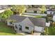 Aerial view of property showcasing well-maintained roof, landscaping, and neighborhood at 649 Caribou Ct, Poinciana, FL 34759