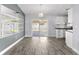 Bright dining room featuring gray tile flooring, a modern pendant light, and view to the kitchen at 649 Caribou Ct, Poinciana, FL 34759