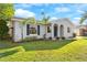 Charming single-story home with palm trees and a well-manicured front lawn at 649 Caribou Ct, Poinciana, FL 34759