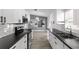 Updated kitchen featuring stainless steel appliances, black countertops, and subway tile backsplash at 649 Caribou Ct, Poinciana, FL 34759