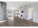 Open-concept living area with gray tile flooring and view to the kitchen at 649 Caribou Ct, Poinciana, FL 34759