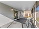 Covered patio offers outdoor living space with screened walls and concrete flooring at 649 Caribou Ct, Poinciana, FL 34759