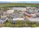Picturesque aerial view of a colorful town by a lake with lush trees and a large parking lot at 660 Celebration Ave # 220, Celebration, FL 34747