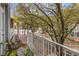 Cozy balcony overlooking a tree-lined street with quaint architecture and pedestrian activity at 660 Celebration Ave # 220, Celebration, FL 34747