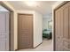 Hallway leading to bedroom with large closets and bright natural light at 660 Celebration Ave # 220, Celebration, FL 34747