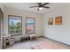 Spacious bedroom featuring two windows with blinds and ample natural light at 660 Celebration Ave # 220, Celebration, FL 34747
