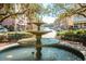 Picturesque view of the community fountain lined with shops and dining areas surrounded by shady trees at 660 Celebration Ave # 220, Celebration, FL 34747
