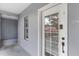 Hallway with a light gray wall and white door with glass panels and silver door number at 660 Celebration Ave # 220, Celebration, FL 34747