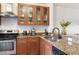Kitchen with light wood cabinets, granite counters, and modern appliances at 660 Celebration Ave # 220, Celebration, FL 34747