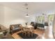 Open-concept living space with hardwood floors, neutral decor, and ample natural light at 660 Celebration Ave # 220, Celebration, FL 34747