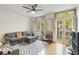 Comfortable living room with hardwood floors, ceiling fan, and large windows at 660 Celebration Ave # 220, Celebration, FL 34747