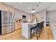 Modern kitchen featuring stainless steel appliances, a large island with bar seating, and hardwood floors at 703 Grand Royal Cir, Winter Garden, FL 34787