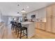 Kitchen with a large island, stainless steel appliances, quartz countertops, and hardwood floors at 703 Grand Royal Cir, Winter Garden, FL 34787