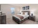 Comfortable bedroom with a large bed, two nightstands, and tasteful decor provides a relaxing space at 7180 Oakmoss Loop, Davenport, FL 33837