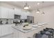 Well-equipped kitchen with granite countertops, stainless steel appliances, and ample counter space for cooking at 7180 Oakmoss Loop, Davenport, FL 33837