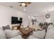 Open-concept living room with seamless flow to the kitchen and dining area, perfect for entertaining and modern living at 7180 Oakmoss Loop, Davenport, FL 33837